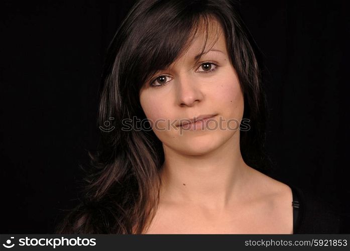 Young beautiful woman portrait on black background