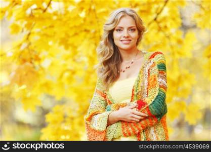 Young beautiful woman posing in autumn park