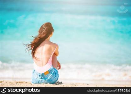 Young beautiful woman relaxing at white sand tropical beach. Young beautiful woman on the beach vacation