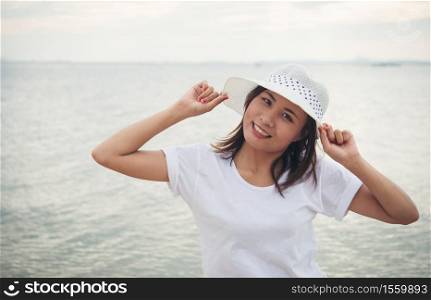 Young beautiful woman relaxing enjoy with the beach. Women lifestyle concept.