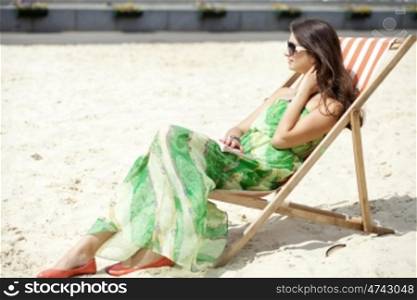 Young beautiful woman relaxing lying on a sun lounger