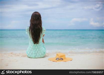 Young beautiful woman relaxing on the beach. Woman laying on the beach enjoying summer holidays looking at the sea