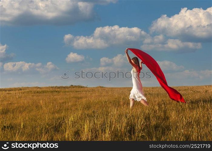 Young beautiful woman running while holding a red tissue