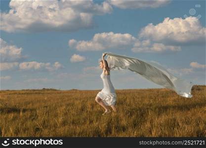 Young beautiful woman running while holding a white tissue