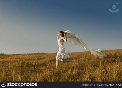 Young beautiful woman running while holding a white tissue