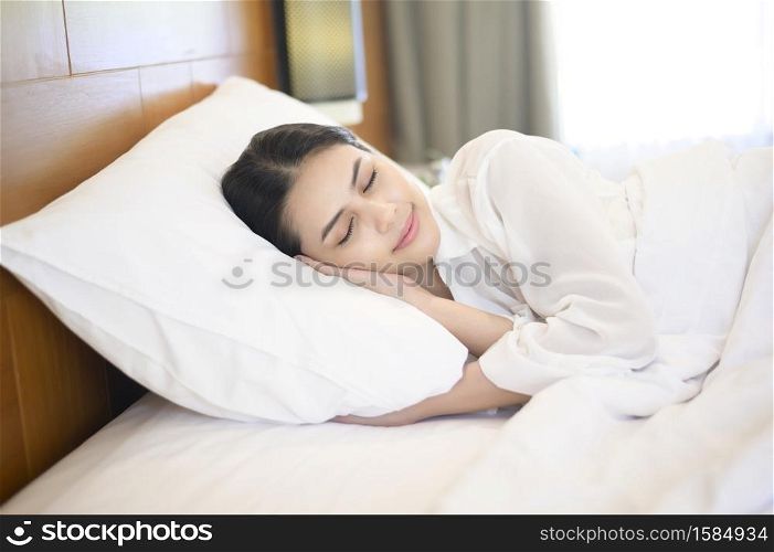 Young beautiful woman sleeping in her bed at home