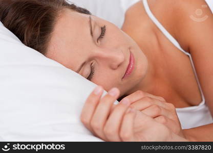 Young beautiful woman sleeping in white bed