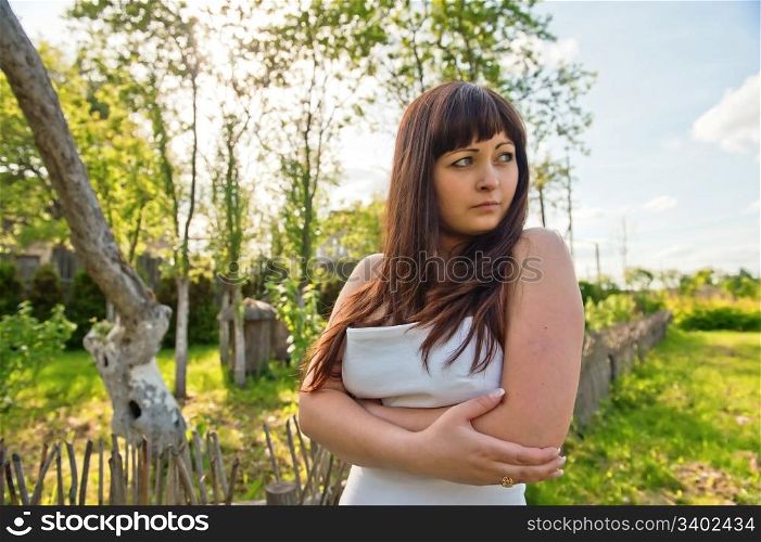Young, beautiful woman stand in farmstead.