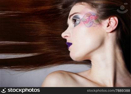 young beautiful woman straight long hair colorful make up grey background