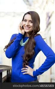 Young beautiful woman talking on cell phone