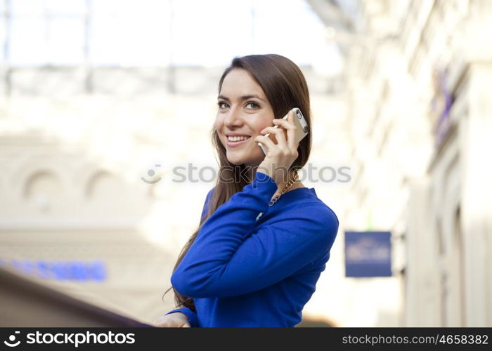 Young beautiful woman talking on cell phone