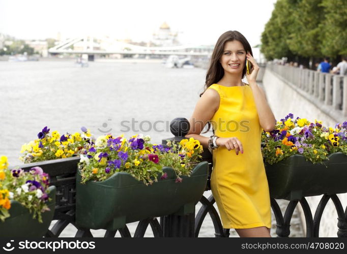 Young beautiful woman talking on cell phone