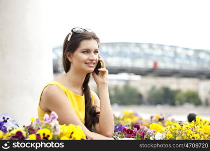 Young beautiful woman talking on cell phone