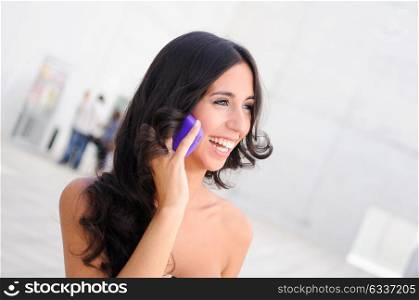 Young beautiful woman talking on phone