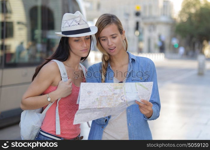 young beautiful woman travelers exploring the city