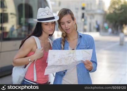 young beautiful woman travelers exploring the city