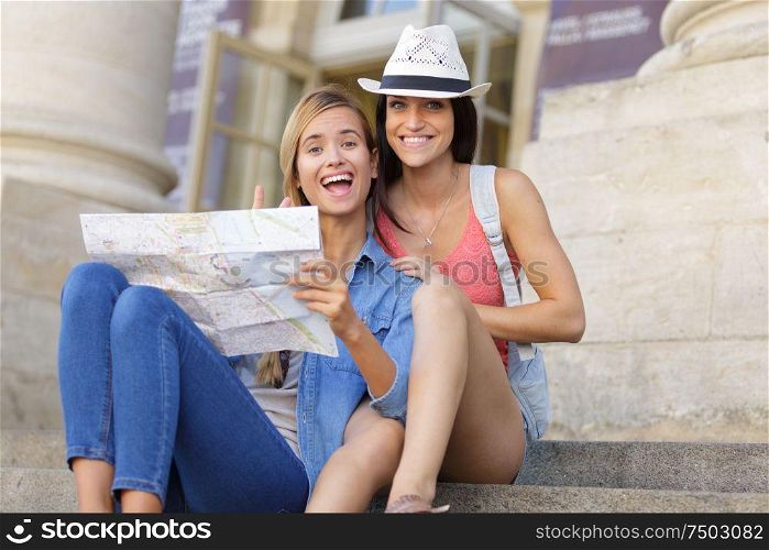 young beautiful woman travelers exploring the city