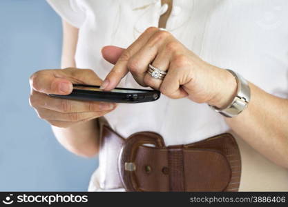 Young beautiful woman using her cell phone