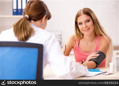 Young beautiful woman visiting doctor for blood pressure . The young beautiful woman visiting doctor for blood pressure 