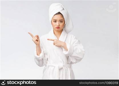 Young beautiful woman wearing shower towel after bath over isolated white background pointing with finger. Young beautiful woman wearing shower towel after bath over isolated white background pointing with finger.