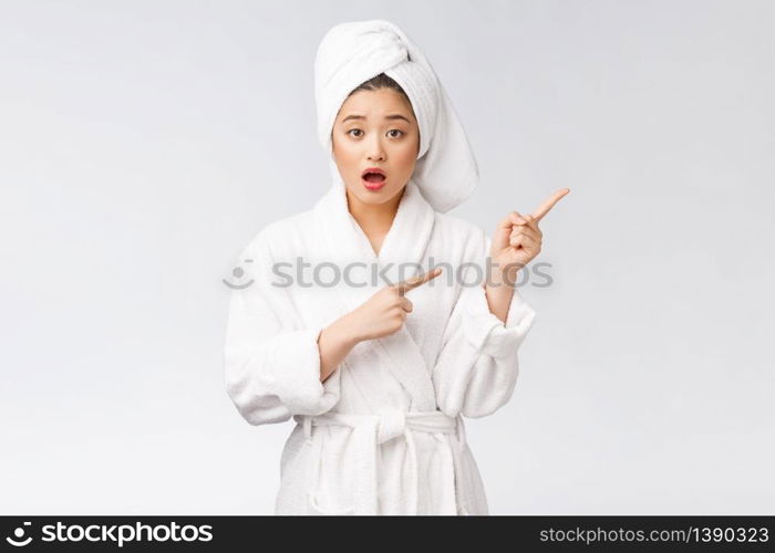 Young beautiful woman wearing shower towel after bath over isolated white background pointing with finger. Young beautiful woman wearing shower towel after bath over isolated white background pointing with finger.