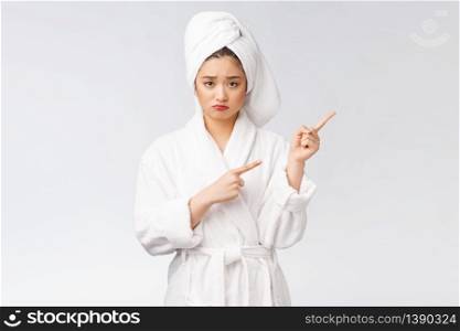 Young beautiful woman wearing shower towel after bath over isolated white background pointing with finger. Young beautiful woman wearing shower towel after bath over isolated white background pointing with finger.