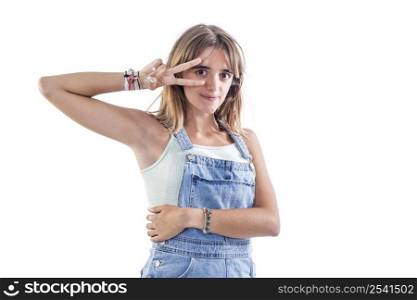 young beautiful woman wearing texan jumpsuit against white wall Doing peace symbol with fingers over face, smiling cheerful showing victory