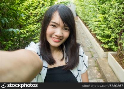 Young beautiful woman wearing winter clothing and photo selfie, asian beauty.