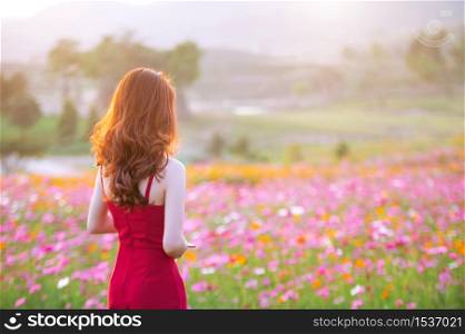 Young beautiful woman with a Cosmos flower.