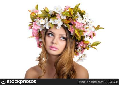 Young beautiful woman with a wreath of spring flowers, isolated on white