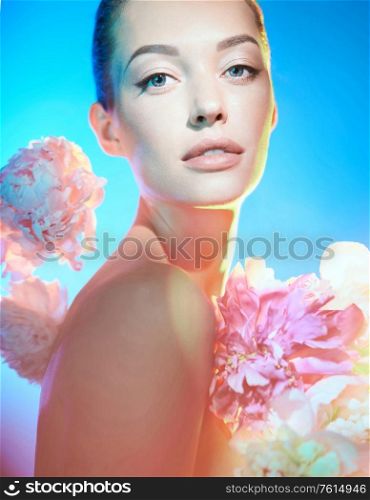Young beautiful woman with bouquet of roses. Art portrait of brunnette with colorful flowers. Professional art makeup. Pretty girl isolated on white background.