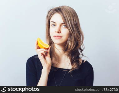 young beautiful woman with citrus orange fruit having fun.