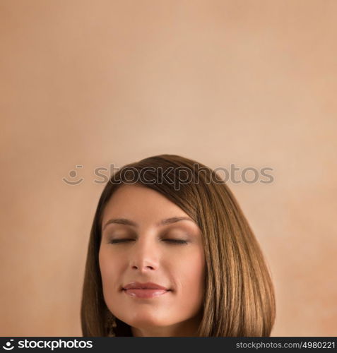 Young beautiful woman with closed eyes and copyspace overhead