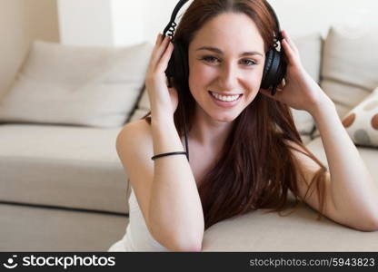 young beautiful woman with headphones at home