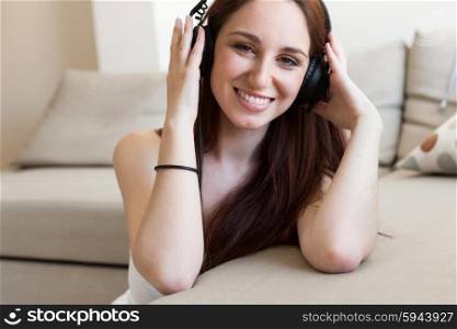 young beautiful woman with headphones at home