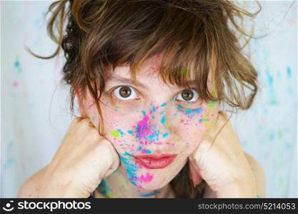 Young beautiful woman with paint in her face