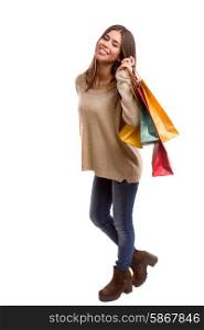 Young beautiful woman with shopping bags, isolated over copy space background