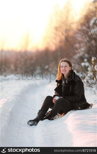 Young beautiful woman with short hair, in checkered scarf walking in snowy forest at sunset. Christmas holiday. Snow day fun.. Young beautiful woman with short hair, in checkered scarf walking in snowy forest at sunset. Christmas holiday. Snow day fun