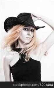 Young beautiful woman with silver make-up in a cowboy hat on a white background