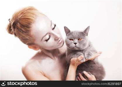 Young beautiful woman with silver makeup on his face holding gray cat British
