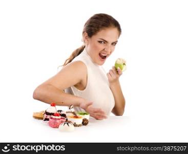 Young beautiful women eating apple and refusing cookies