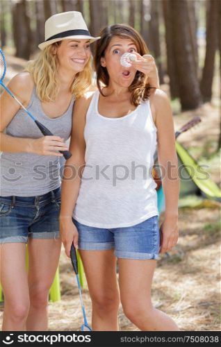 young beautiful women playing badminton in the park