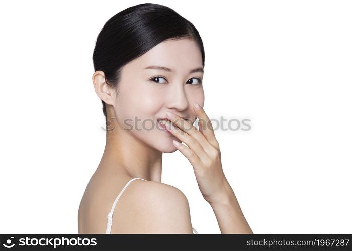 Young beauty covering her mouth and smiling