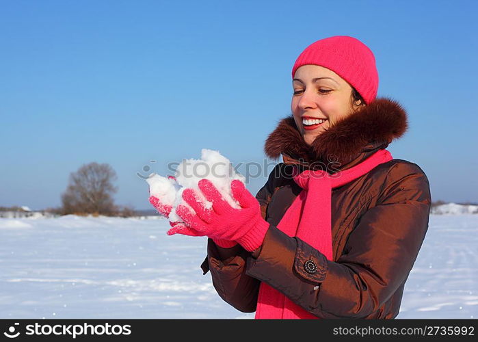 young beauty girl outdoor in winter holds snow in hands