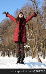 young beauty girl standing and putting hands up, outdoor at winter day