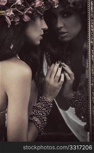 Young beauty in a mirror