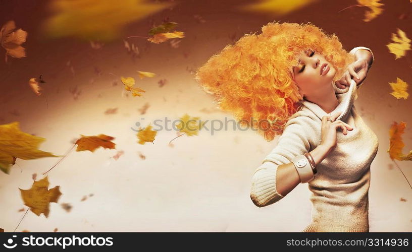 Young beauty on autumn studio background