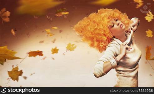 Young beauty on autumn studio background