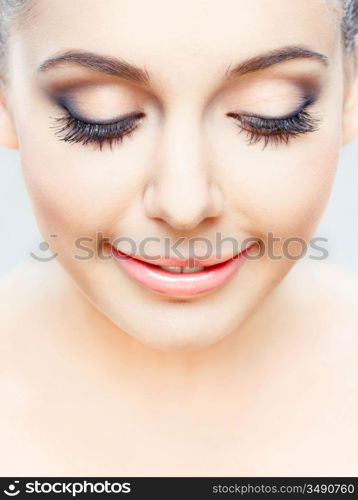 young beauty posing with eyes closed, studio shot