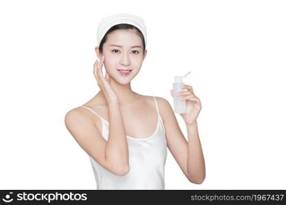 Young beauty spraying skin care products